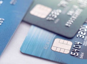 Close up image of partial credit cards strewn atop each other.