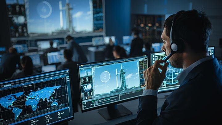 Man sits in missile launch control room during lift off working on embedded system. Man sits in missile launch control room during lift off working on embedded system